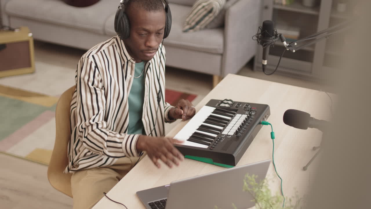 African American Man Making Music in Home Studio