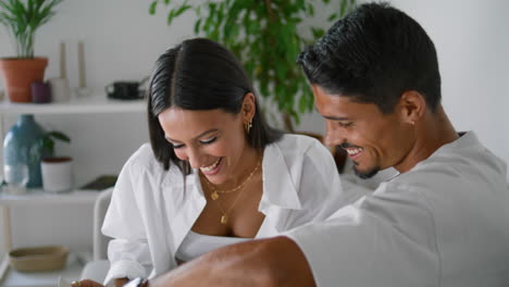 positive lovers laughing home vertical closeup. married couple reading book