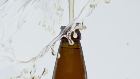 cap popping beer bottle in super slow motion close up. explosion golden alcohol.