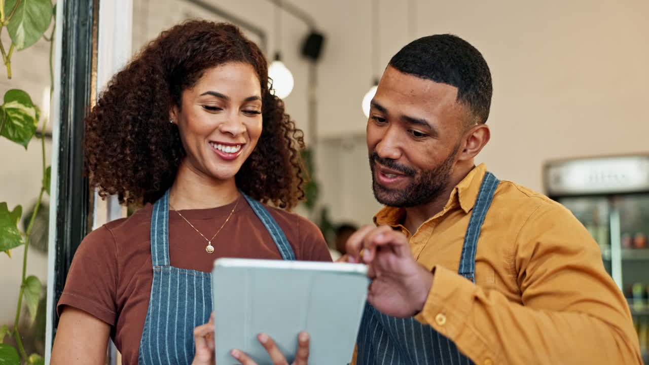 Cafe Owners Using Tablet to Manage Their Business
