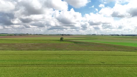 Aerial-view-of-the-green-countryside-north-of-Paris,-showcasing-vast-fields-and-serene-landscapes