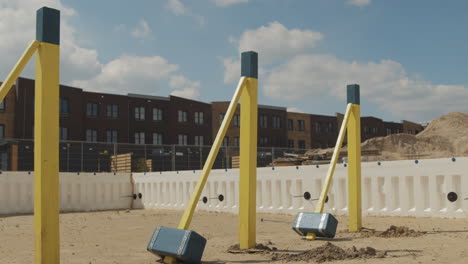 three wooden hamers standing next to three wooden poles