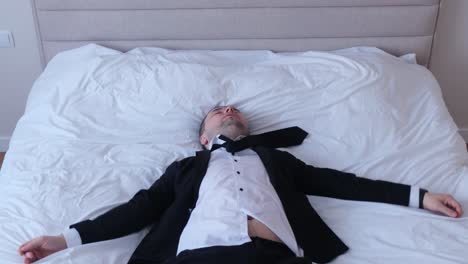 Office Worker Lying on Bed After Working Week. Office worker lying on bed after working week. Migraine and fatigue in a man. Depression