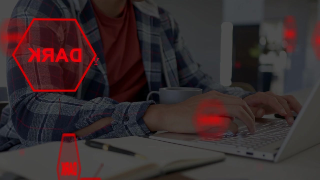 Man typing on laptop and activating red UI overlays for technology demo, hexagons moving over desk