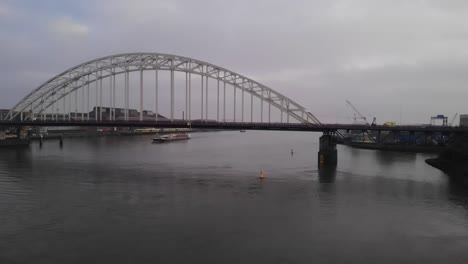 Aerial-shot-of-arch-bridge-over-Noord-River-in-netherlands