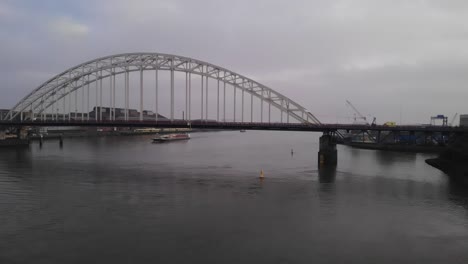 aerial shot of arch bridge over noord river in netherlands