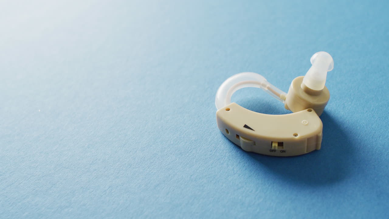 Video of hearing aid on blue background with copy space