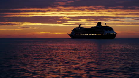 cruise ship on the ocean at sunset