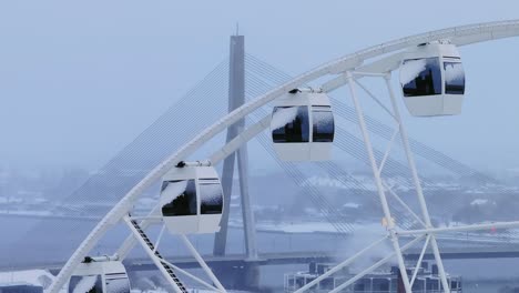 white ferris wheel, iconic vanšu bridge of drone, overcast winter day, riga, 4k
