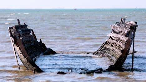 old boat remains in chonburi's sea waves