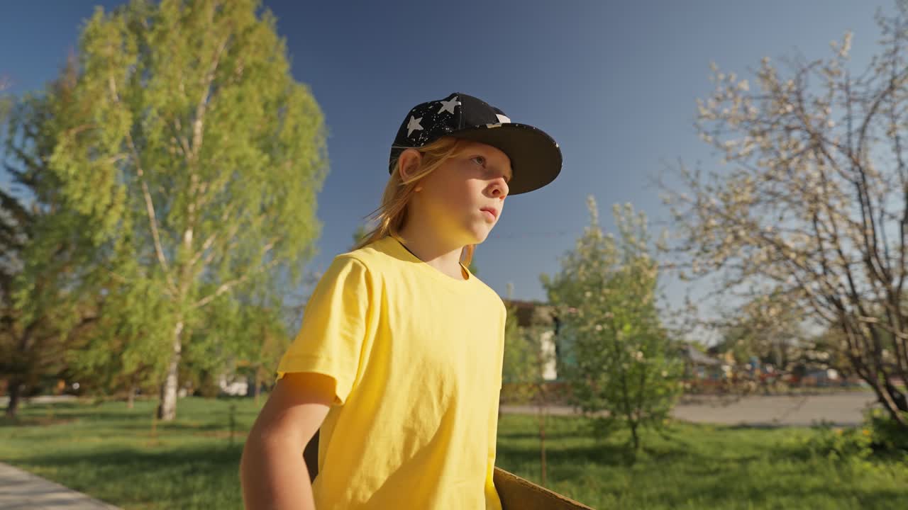 Boy with skateboard in a park