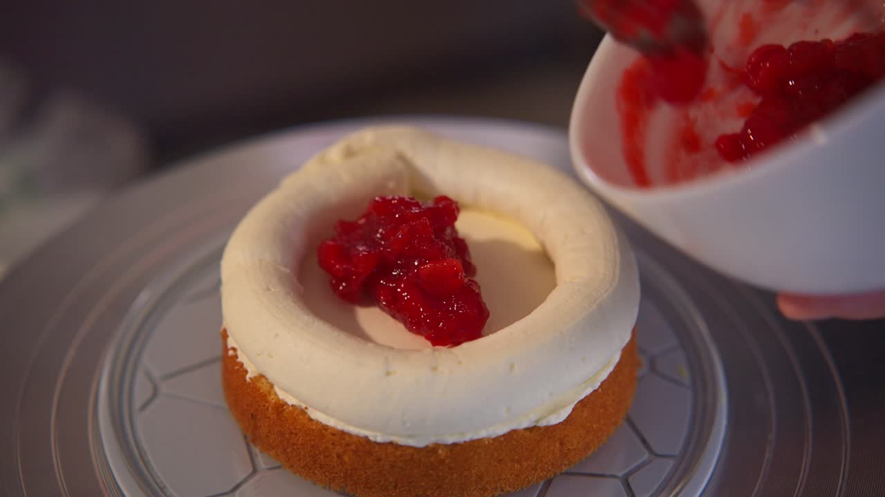 Adding Red Fruit Filling to a Sponge Cake with Cream