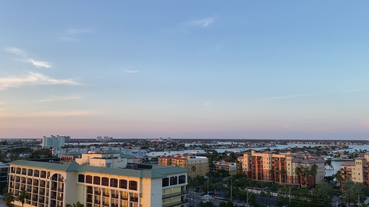 City skyline along the coast at sunset with warm orange light and blue sky in, St. Pete Beach Tampa Bay Florida