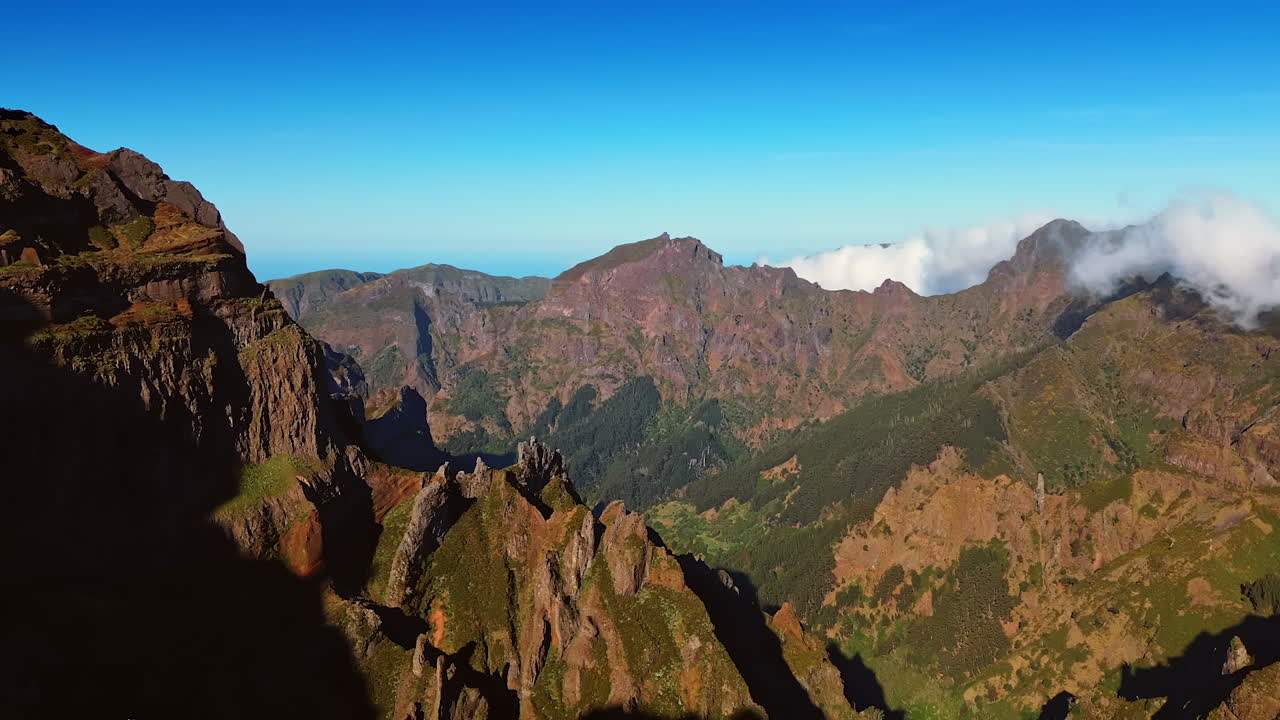 Massive rocks with sharp tops. Bare mountains with poor greenery in the landscape of Madeira, Portugal. Aerial view.