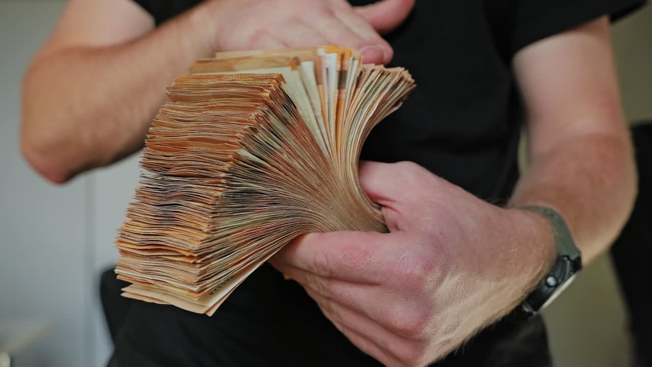 Man flipping euro banknotes symbolizes corruption bribery and illegal economy