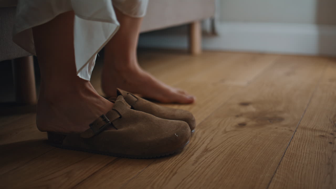 Legs getting bed morning at home closeup. Relaxed lady put on slippers walking