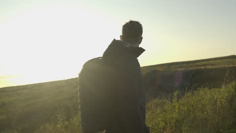 slow motion shot of a tourist hiking along a trail at sunset in iceland