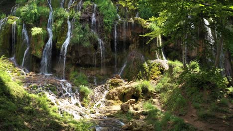 amazing tropical waterfall cascading over rocky forest cliffside, aerial