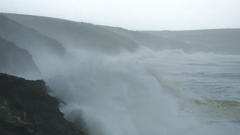 stunning cinematic shot of a huge storm battering the coast near porthleven