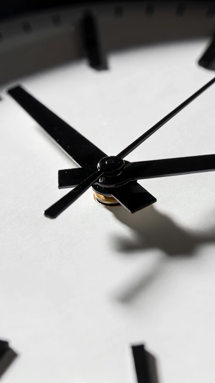 Vertical video: Driving seconds hand by motor, thick hands still on dial in room marking time