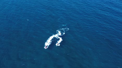 Jet-ski-sailing-at-seascape-in-the-south-coast-of-spain-aerial-drone-view