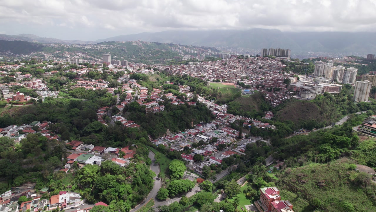 Tilt up aerial reveals La Tahona neighborhood in Baruta, Caracas with homes and trees