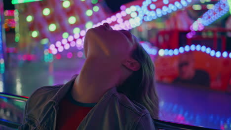 relaxed girl chill nightlife in neon lights closeup. sensual woman in luna park