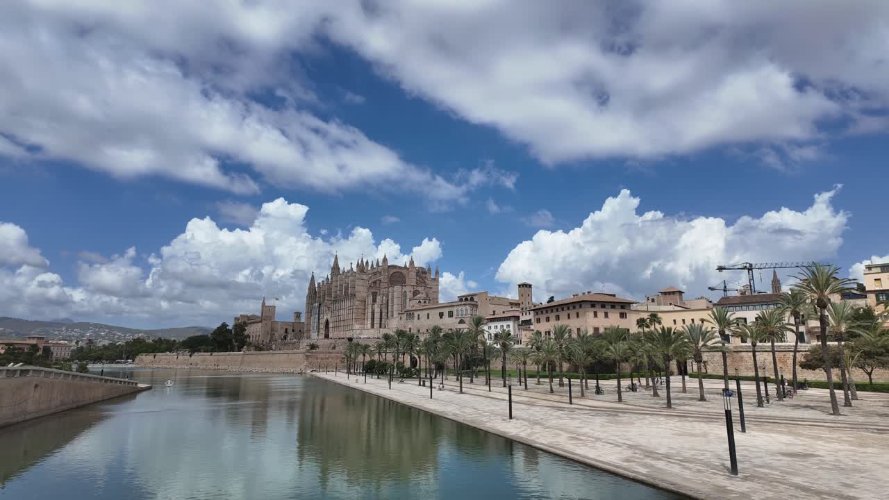Timelapse of Palma de Mallorca historical city center and Cathedral, under a blue sky with a changing sky with some clouds