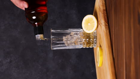 piscola cocktail, typical chilean drink wooden table dark background chile pisco, ice and coke