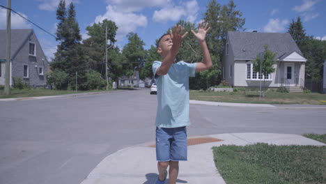 Young-boy-drops-his-football-while-walking-down-the-street