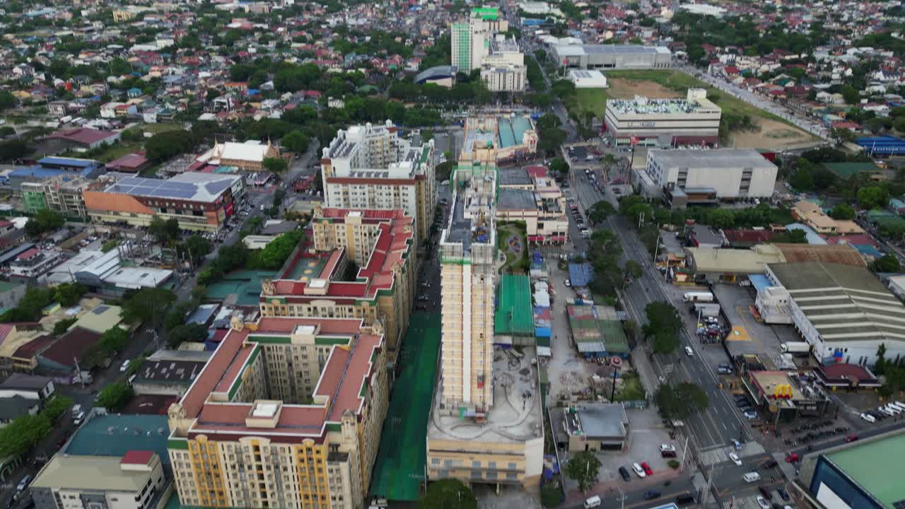 Aerial tilt-up reveal of condominium apartment buildings in densely populated city of Marikina City, Philippines.