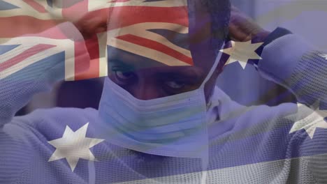 Animation-Der-Flagge-Australiens,-Die-Während-Der-Covid-19-Pandemie-über-Einem-Mann-Mit-Gesichtsmaske-Weht