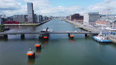 hovering over liffey river in dublin, behind tom clarke bridge