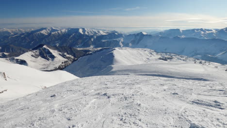 stunning panoramic circle view of snow capped rugged and rough caucasus mountain range on sunny day
