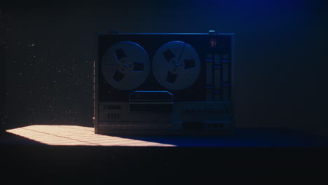 a vintage tape recorder in a blue light