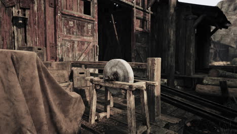 a rustic old shed with a grinding wheel