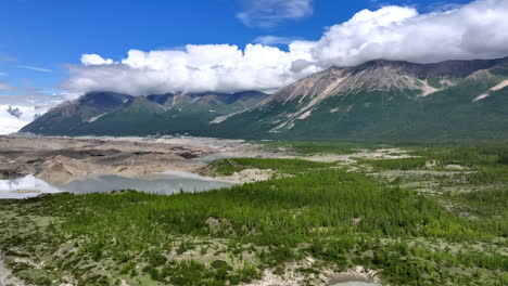 stunning alaskan wilderness. explore the stunning beauty of alaska, featuring majestic mountains and a serene river surrounded by lush greenery