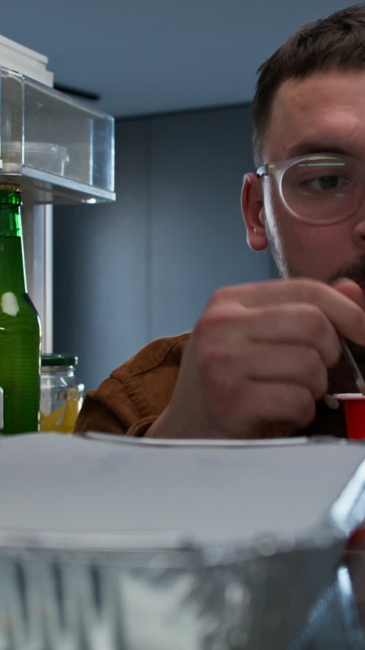 Man taking food out of fridge