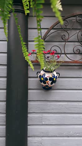 decorative flower pot hanging on a grey house