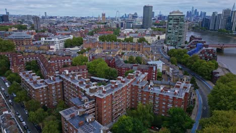 pimlico neighborhood and riverside with millbank tower and big ben in background, london cityscape. aerial drone ascending