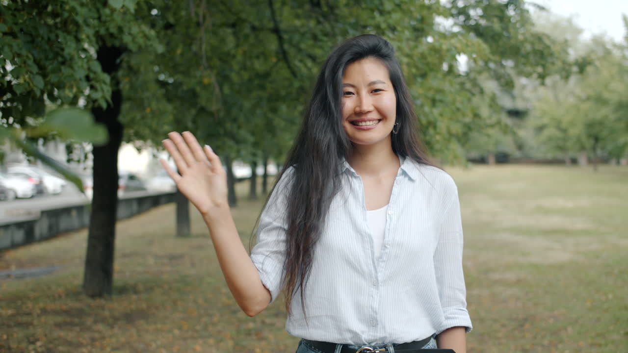 Woman Waving in a Park