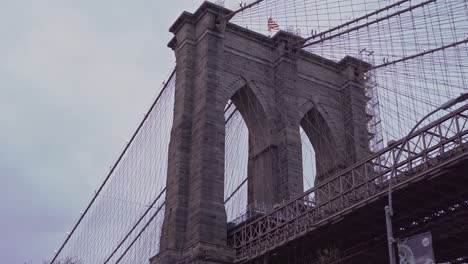 helicopter flies over brooklyn bridge, new york