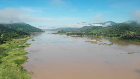 the mekong river ecology and environment affected through chinese funded hydropower dam projects, beautiful mekong river with misty mountains