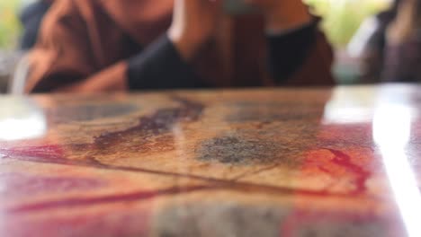 person using a smartphone in a cafe