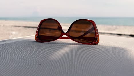 classic stylish sunglasses on sunbed