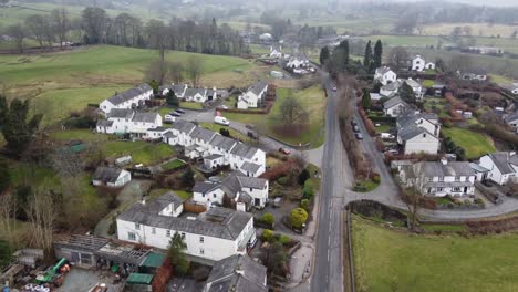 cinematic aerial drone footage of hawkshead village and st michael and all angels church