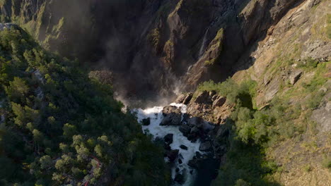 Stomach-churning-view-over-the-edge-of-Voringsfossen-falls,-Norway,-drone