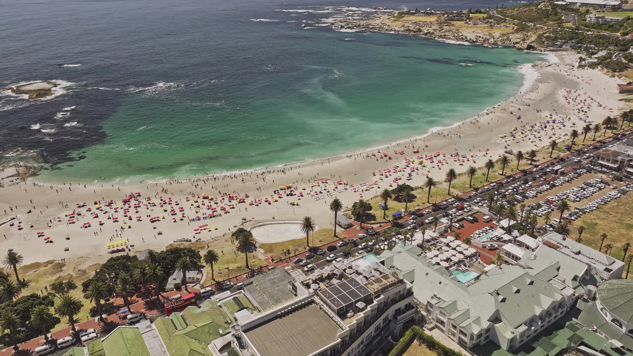 Cape Town South Africa Aerial v81 birds eye view flyover Camps Bay's white sandy beach, tilt up reveals Lion's Head, Signal Hill, and views of Clifton - Shot with Mavic 3 Pro Cine - Jan 11th 2024