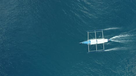 ws aerial ts ha camera following outrigger boat in sea, el nido, palawan, philippines