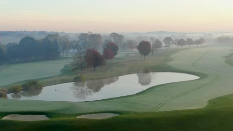 aerial above water hazard on misty foggy morning, golf course, country club view, beautiful morning light